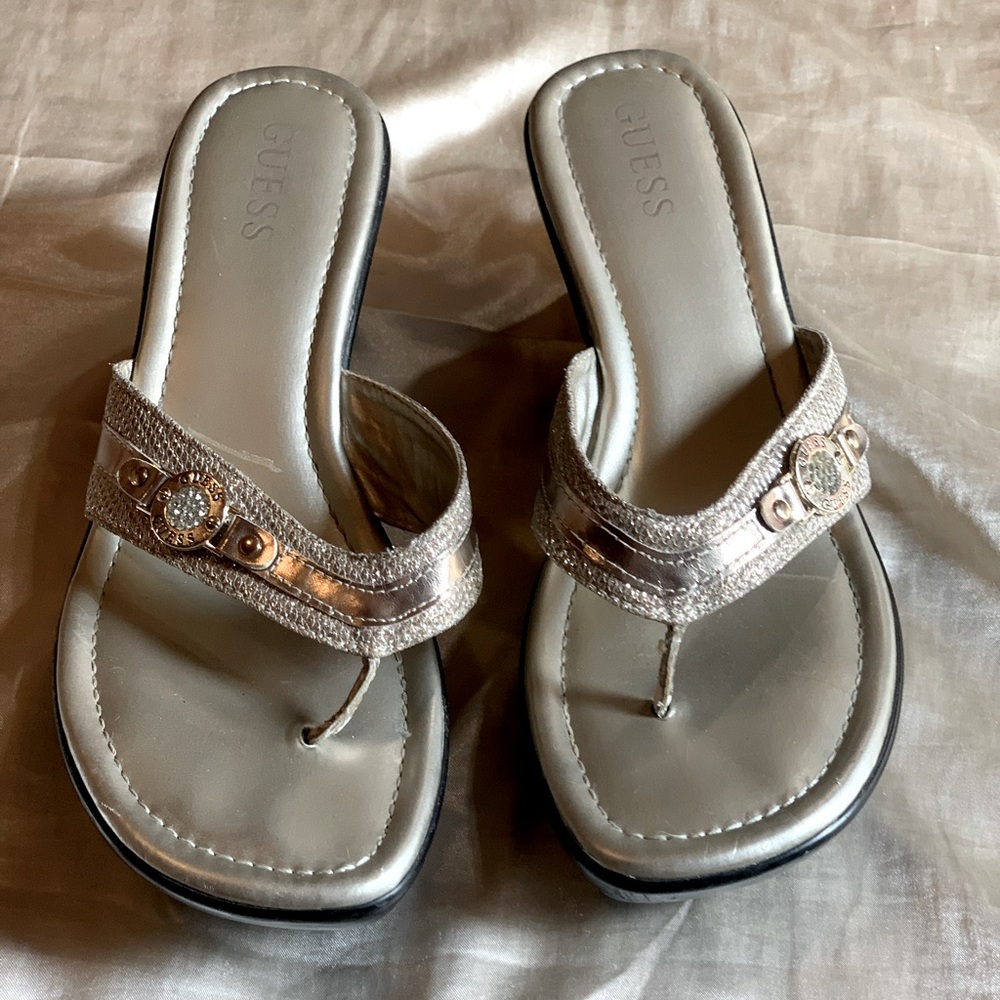 Gold Guess sandals.